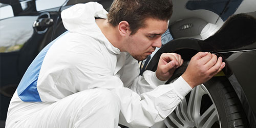 Technician inspecting a car wheel